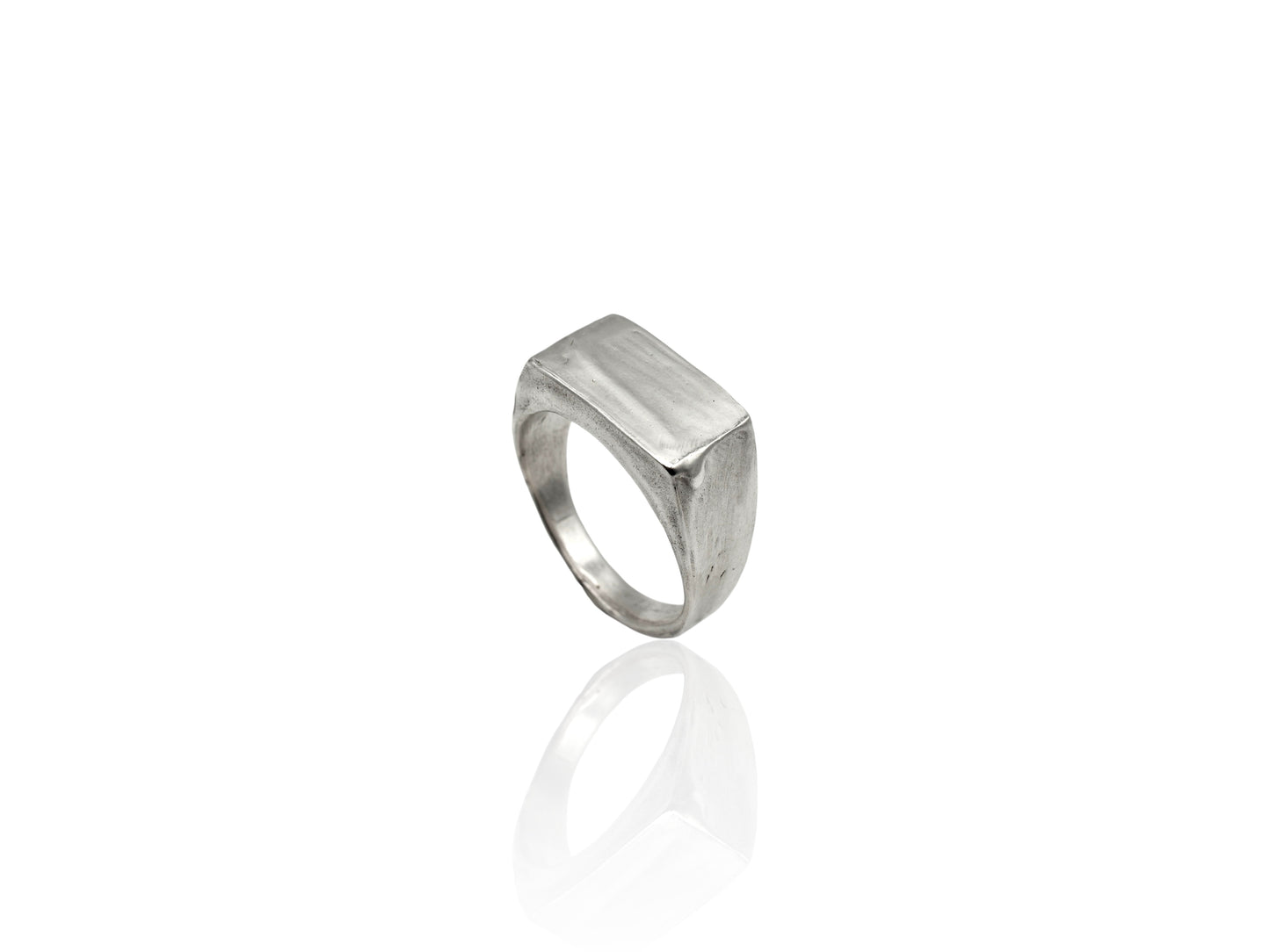 Silver signet ring displayed on white background. silver ring with sculpted organic design and texture. Ring is designed by soul full studio and handmade with lost wax casting and metal smithing techniques.