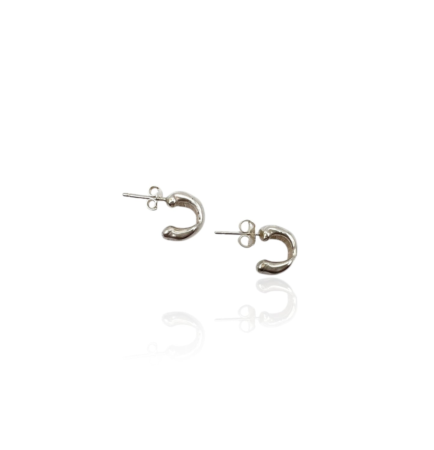 Soul full studio small silver huggies displayed on white background.