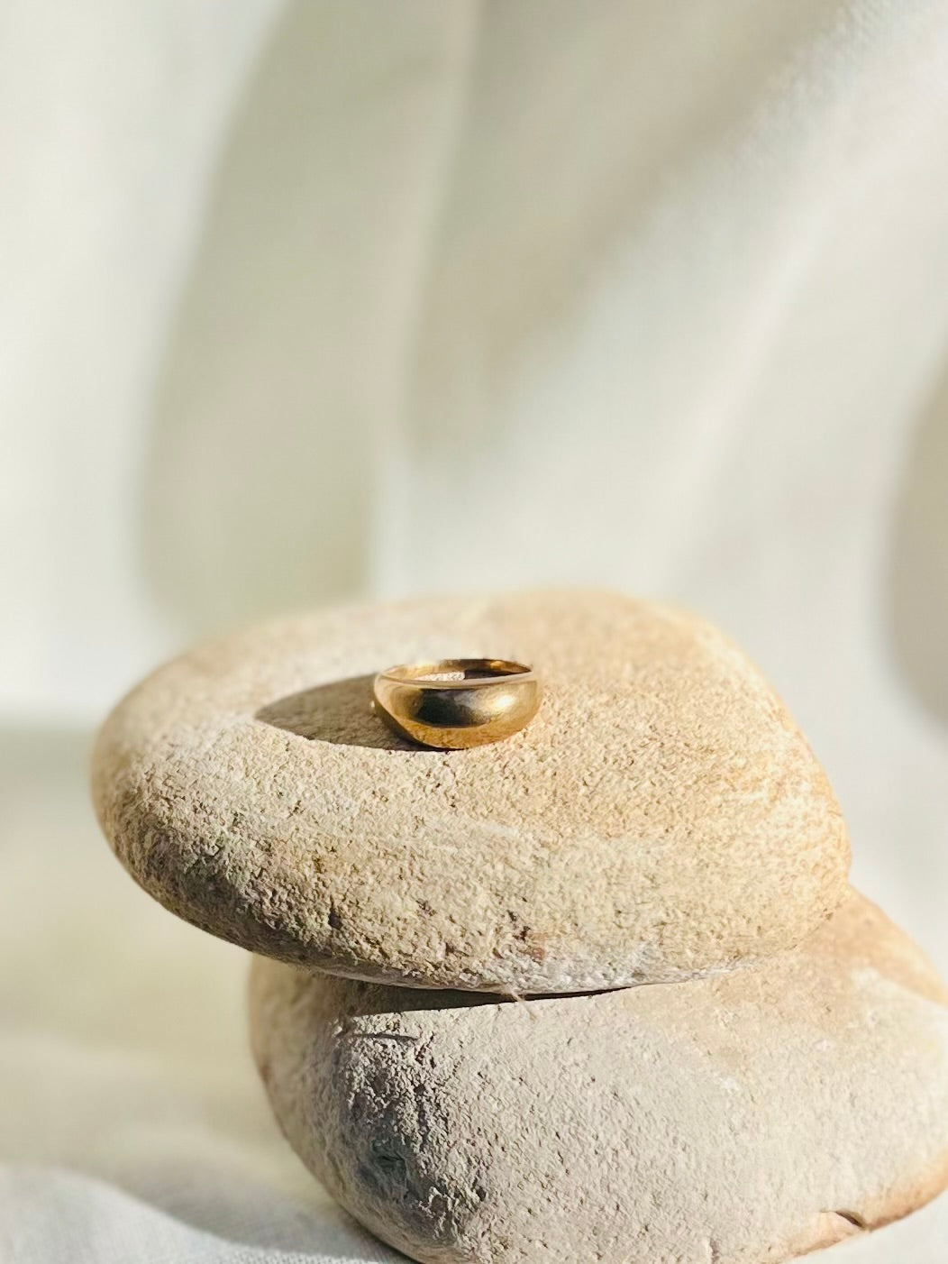 Hand sculpted thin bronze dome ring with rock prop background. Lost wax cast jewelry.