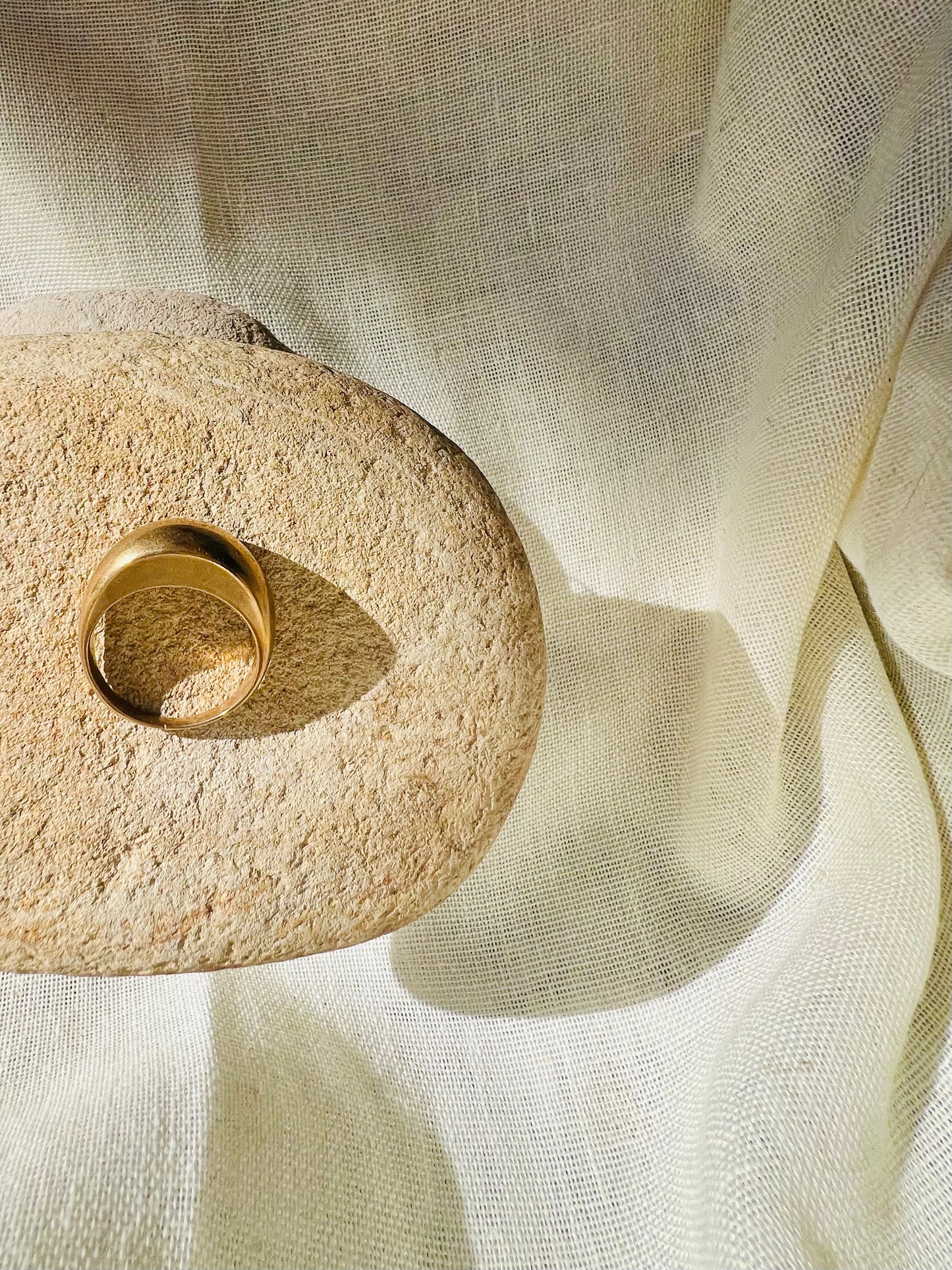 Hand sculpted thin bronze dome ring with rock prop background. Lost wax cast jewelry.