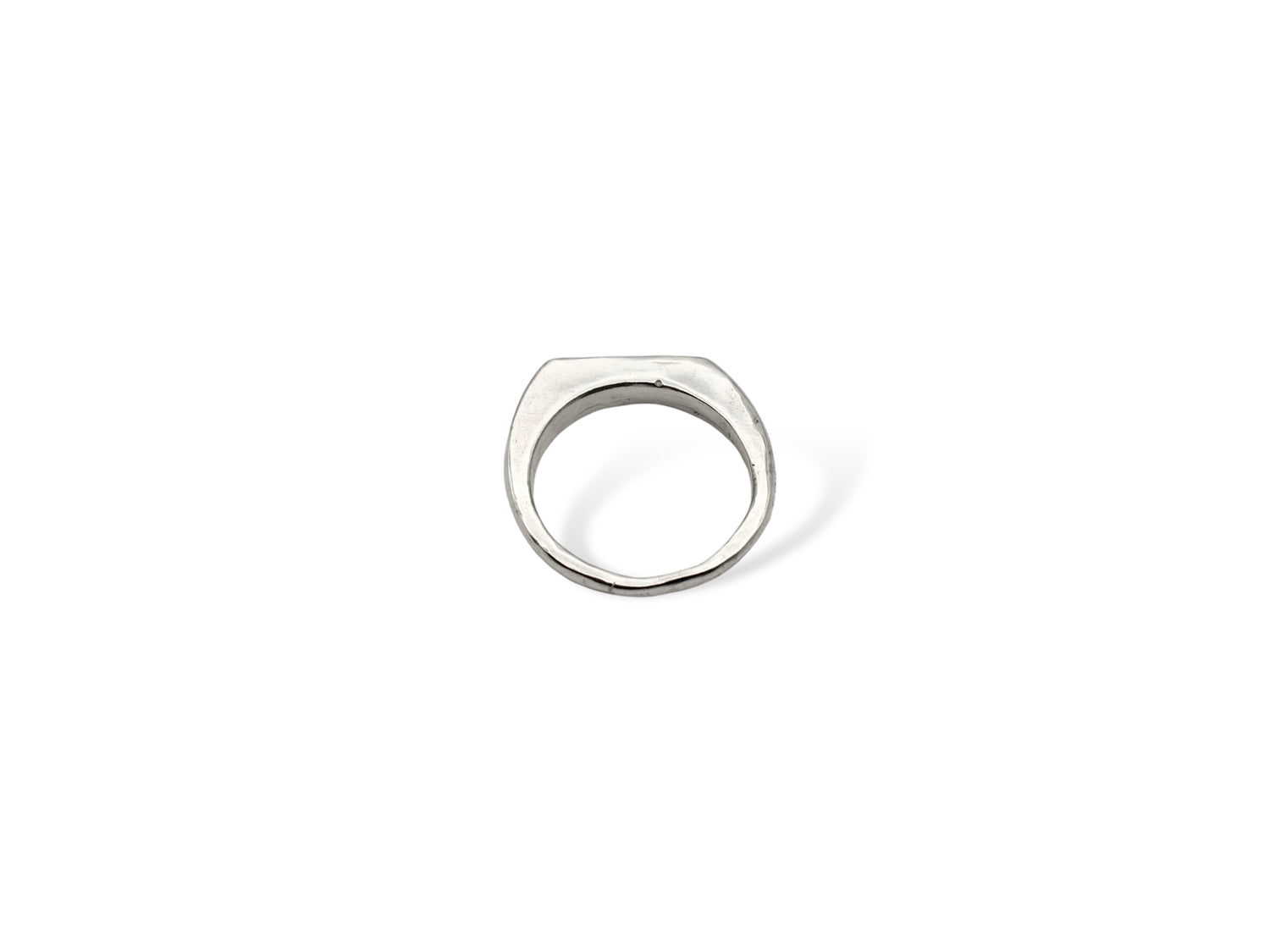 Silver thin signet ring displayed on white background. silver ring with sculpted organic design and texture. Ring is designed by soul full studio and handmade with lost wax casting and metal smithing techniques.