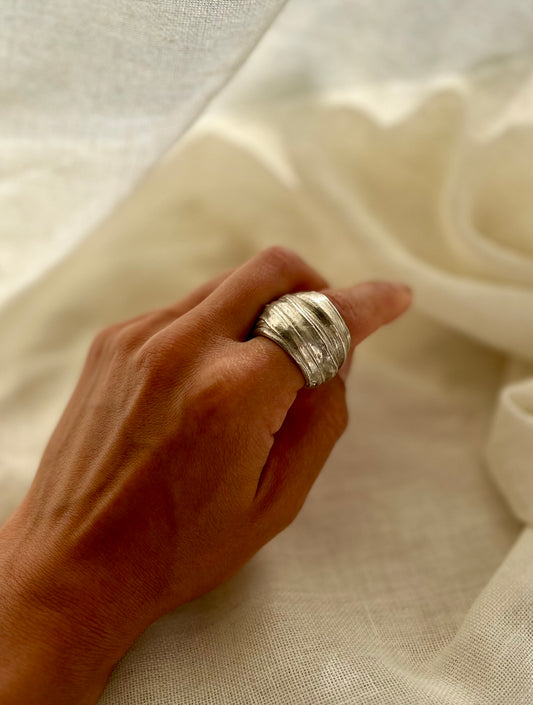 Mitsuro hikime ring on cream linen background. Handmade by Soul Full Studio.