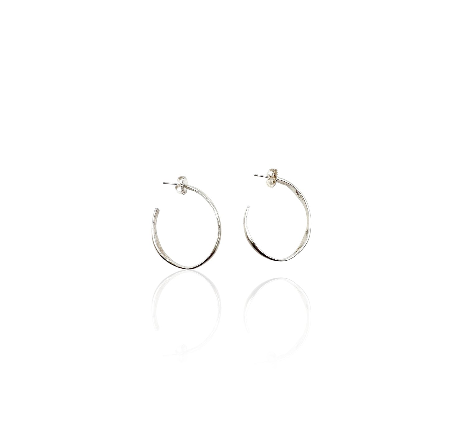 Soul full studio medium silver oval hoops displayed on white background. 