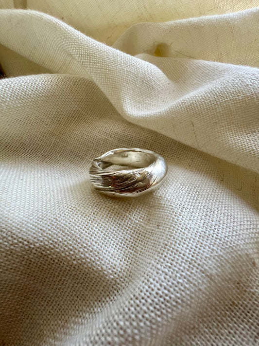 Mitsuro hikime ring on cream linen background. Handmade by Soul Full Studio.