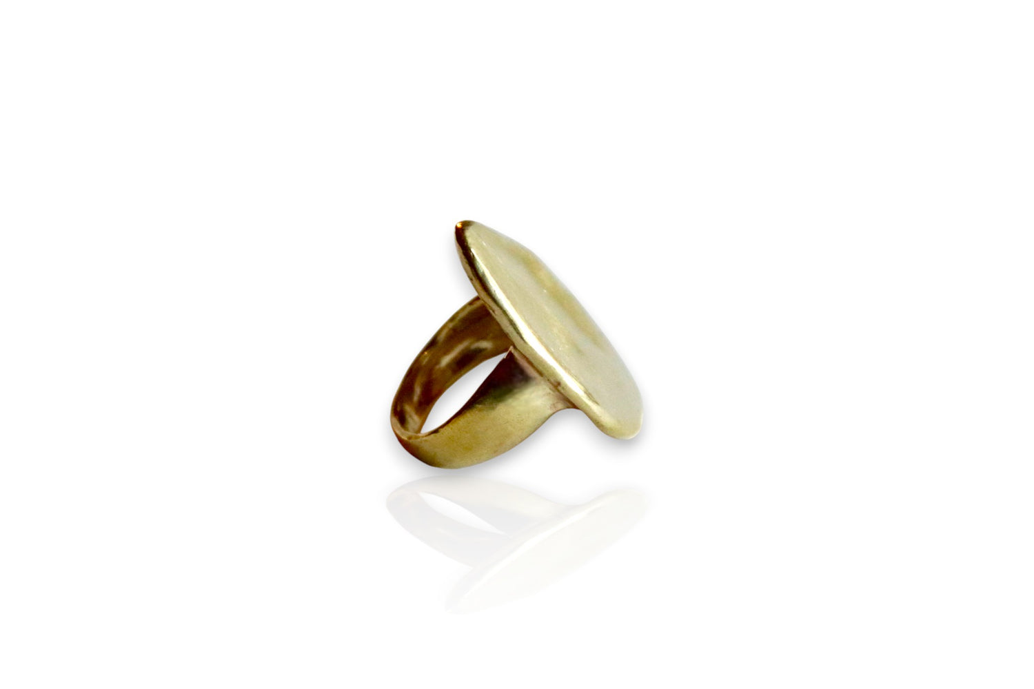 Between earth and sky yellow brass ring. Side view of organic shaped ring. Displayed on white background. 