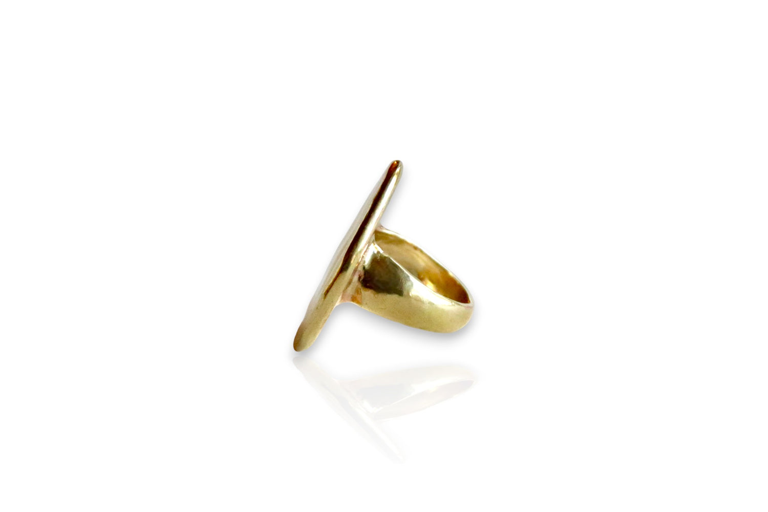 Between earth and sky yellow brass ring. Displayed from the side on white background. 