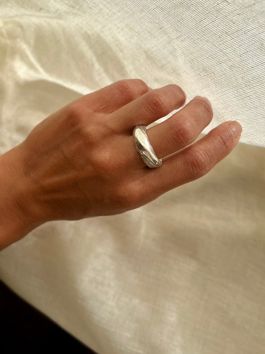 Mitsuro hikime ring on cream linen background. Handmade by Soul Full Studio.