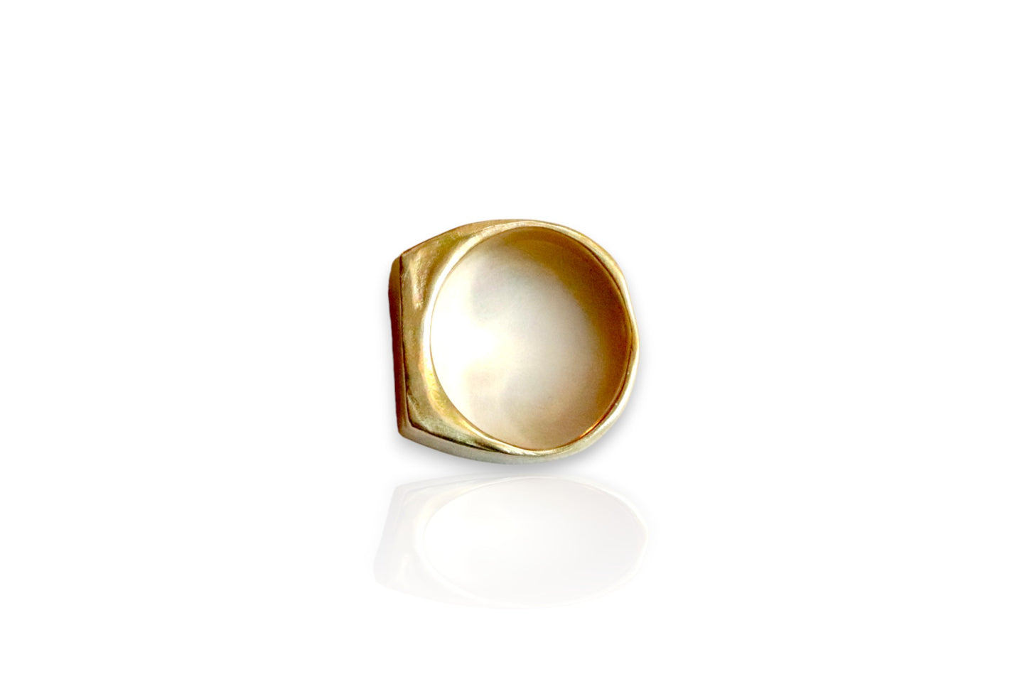 This image displays a yellow brass signet ring with organic, sculpted features.  Image taken from the top view of the ring. Displayed on white background. 
